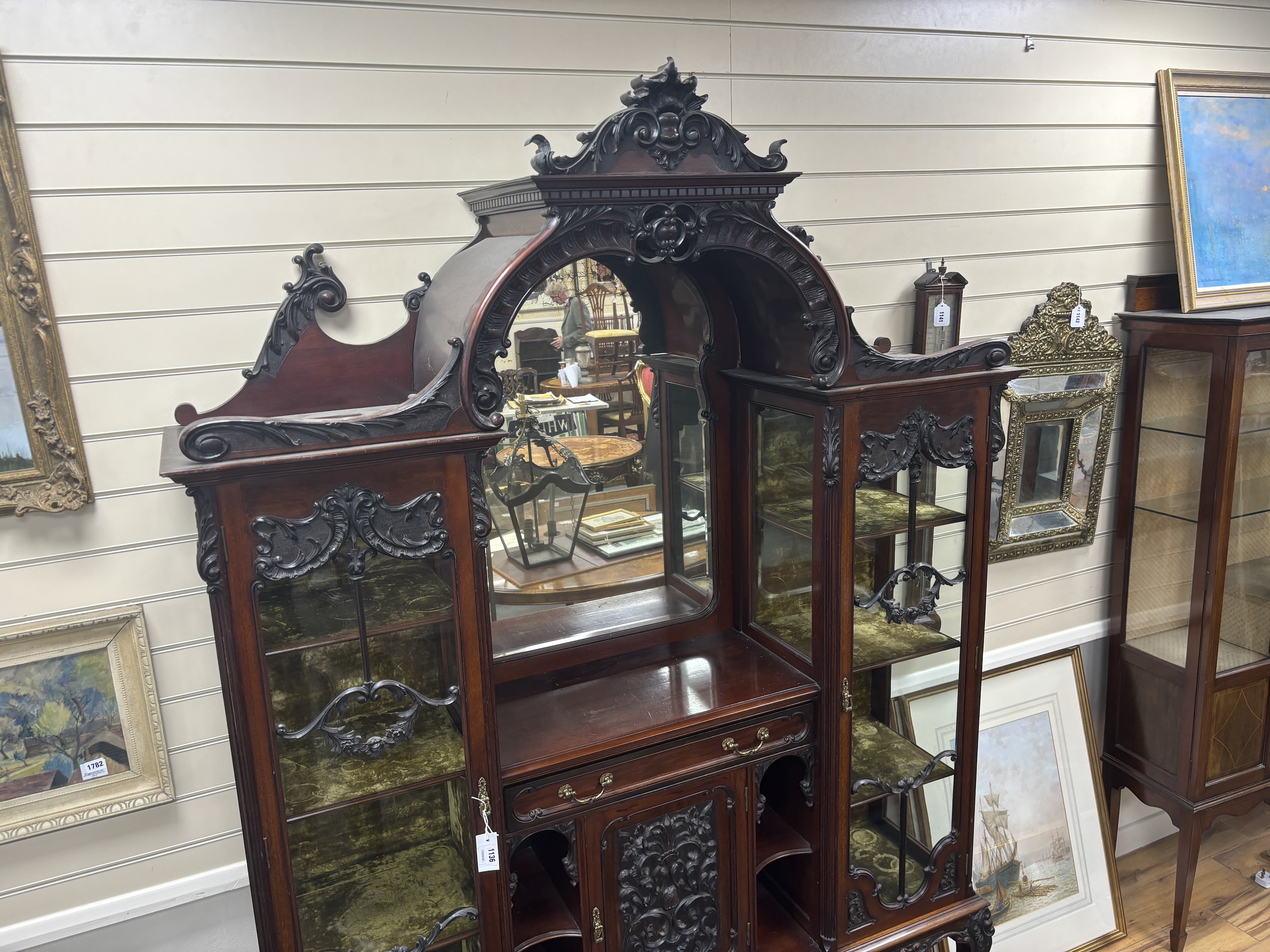 A late Victorian glazed carved mahogany side cabinet, width 157cm, depth 38cm, height 228cm